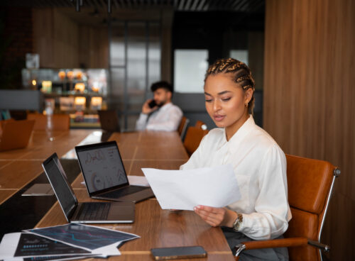 A lady reviewing documents in an office setting.