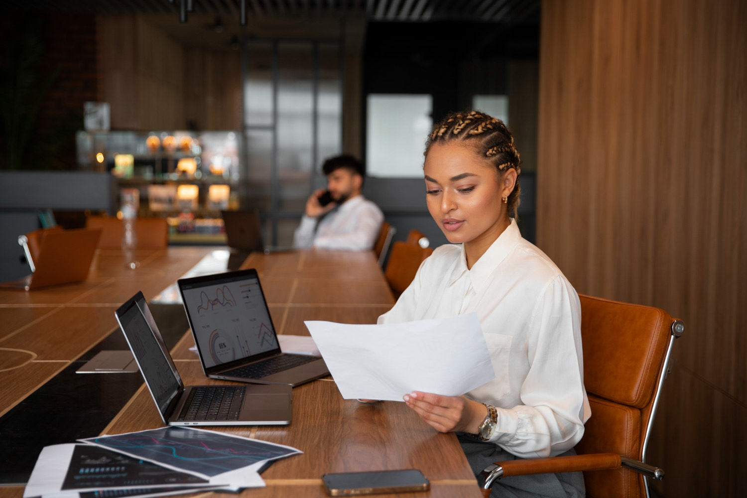 A lady reviewing documents in an office setting.
